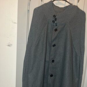gray knit cape coat with button detailing.